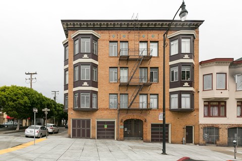 A large brick building with a fire escape on the side.