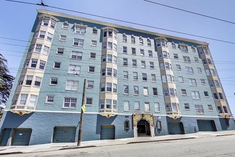 A blue building with a yellow sign on the front.