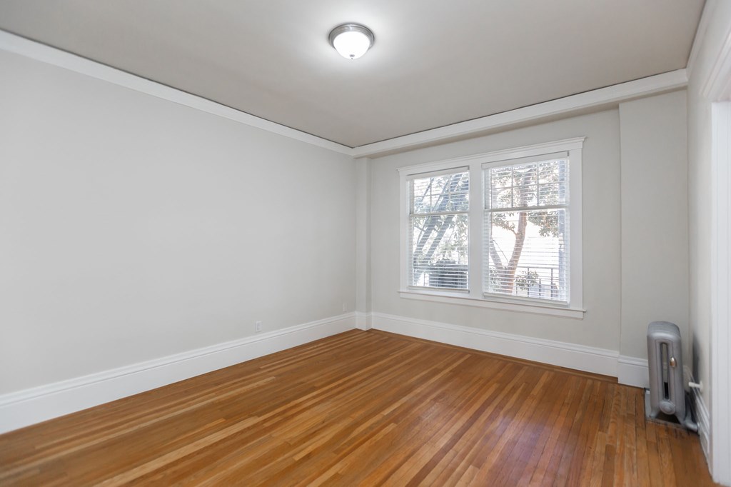 a living room with wood floors and a window