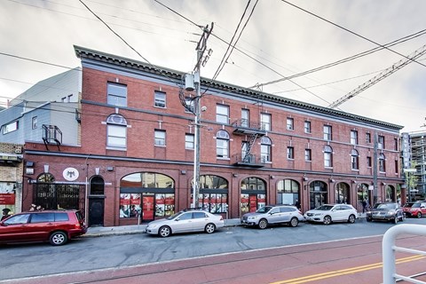 A red brick building with a black door and windows.