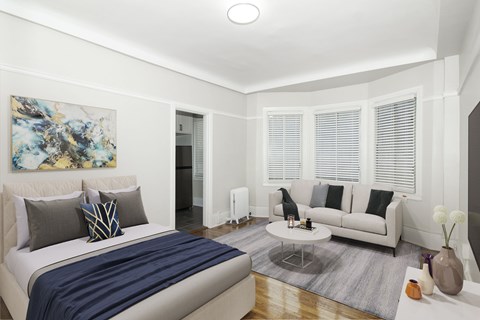 A bedroom with a large bed and a couch.