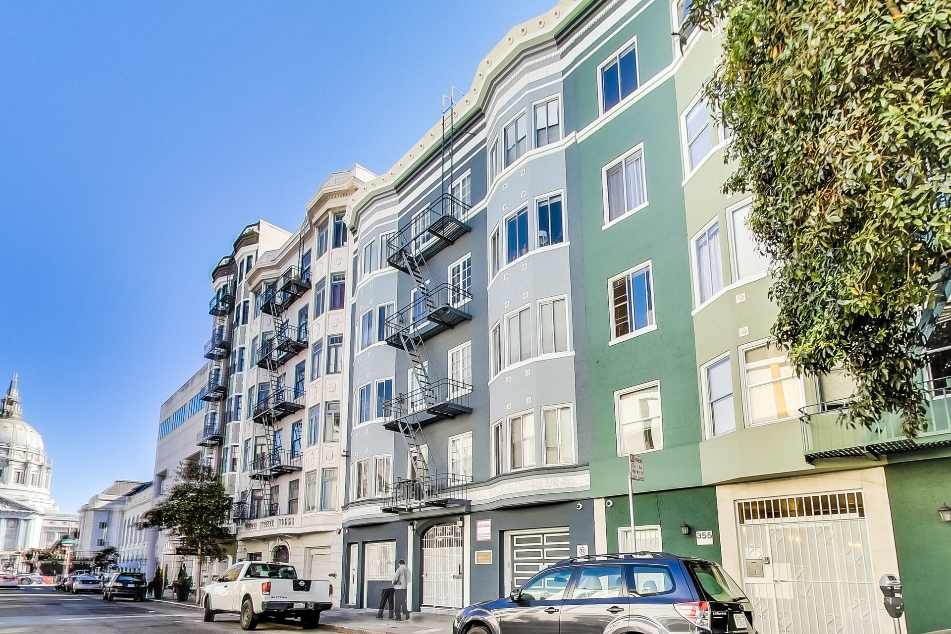 A street view of a city with cars and buildings.