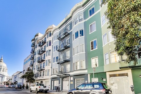 A street view of a city with cars and buildings.