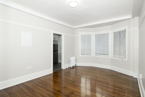 A room with wooden floors and white walls.