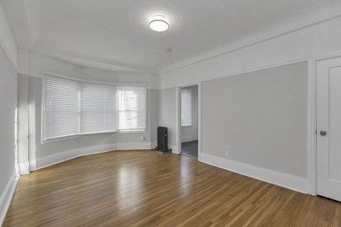 A room with wooden floors and white walls.