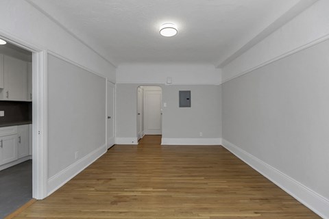 A room with wooden floors and white walls.