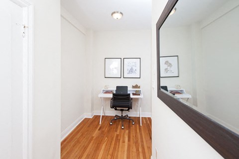 A room with a chair and a desk.