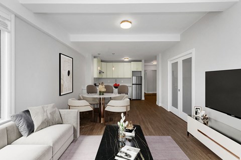 A modern living room with a white sofa and a glass table.