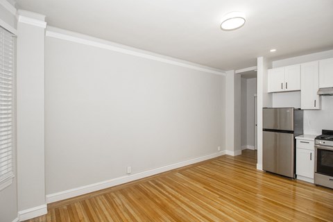 A kitchen with white cabinets and stainless steel appliances.