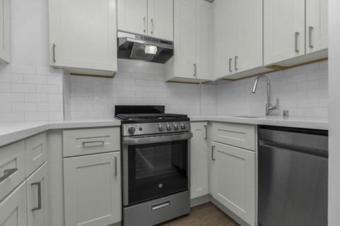 A modern kitchen with a stove and cabinets.