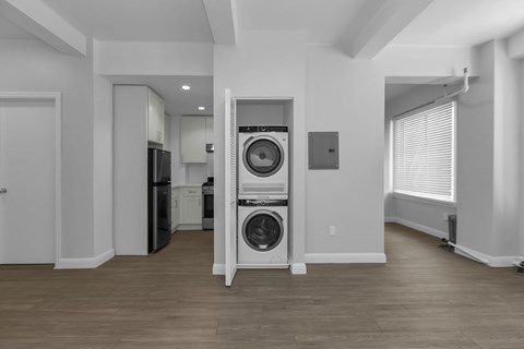 A laundry room with a washer and dryer stacked on top of each other.
