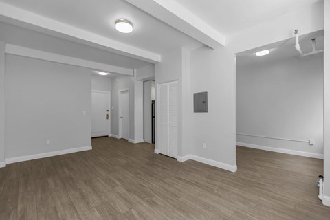 A room with wooden floors and white walls.