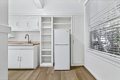 A white refrigerator with its door open in a kitchen.