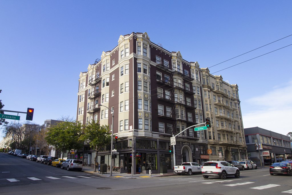 A street view of a city with cars and buildings.