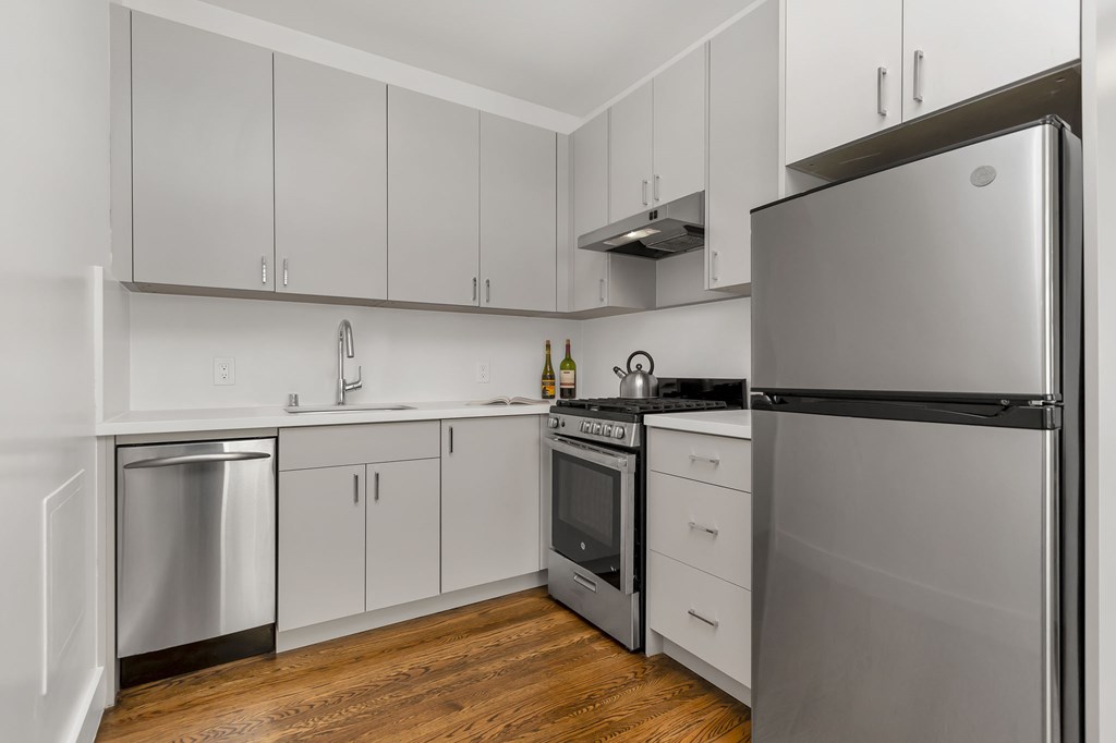 A modern kitchen with a refrigerator on the right.