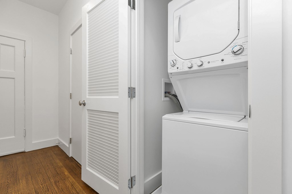 A white oven is built into a wall in a kitchen.