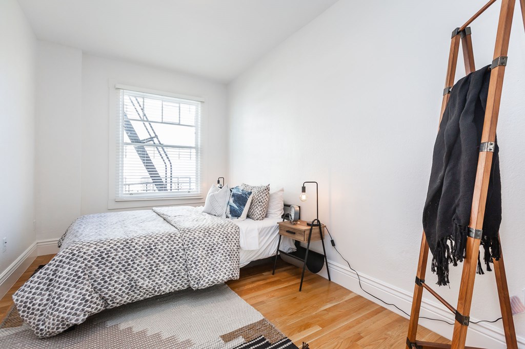 a bedroom with a bed and a window and a ladder
