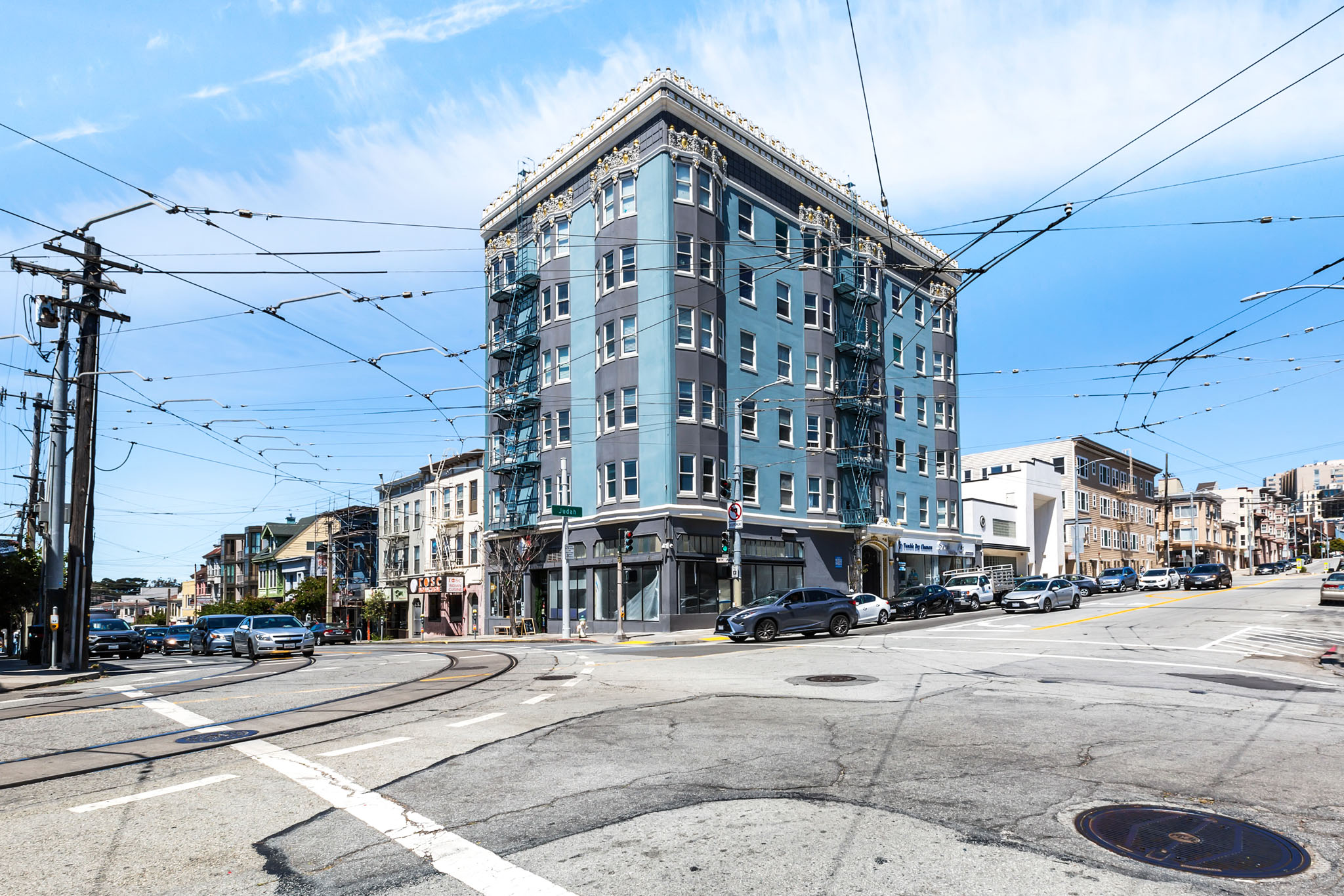 A street view of a city with a large building in the center.