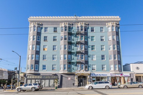 A large building with a blue and grey facade is the focal point of the image.