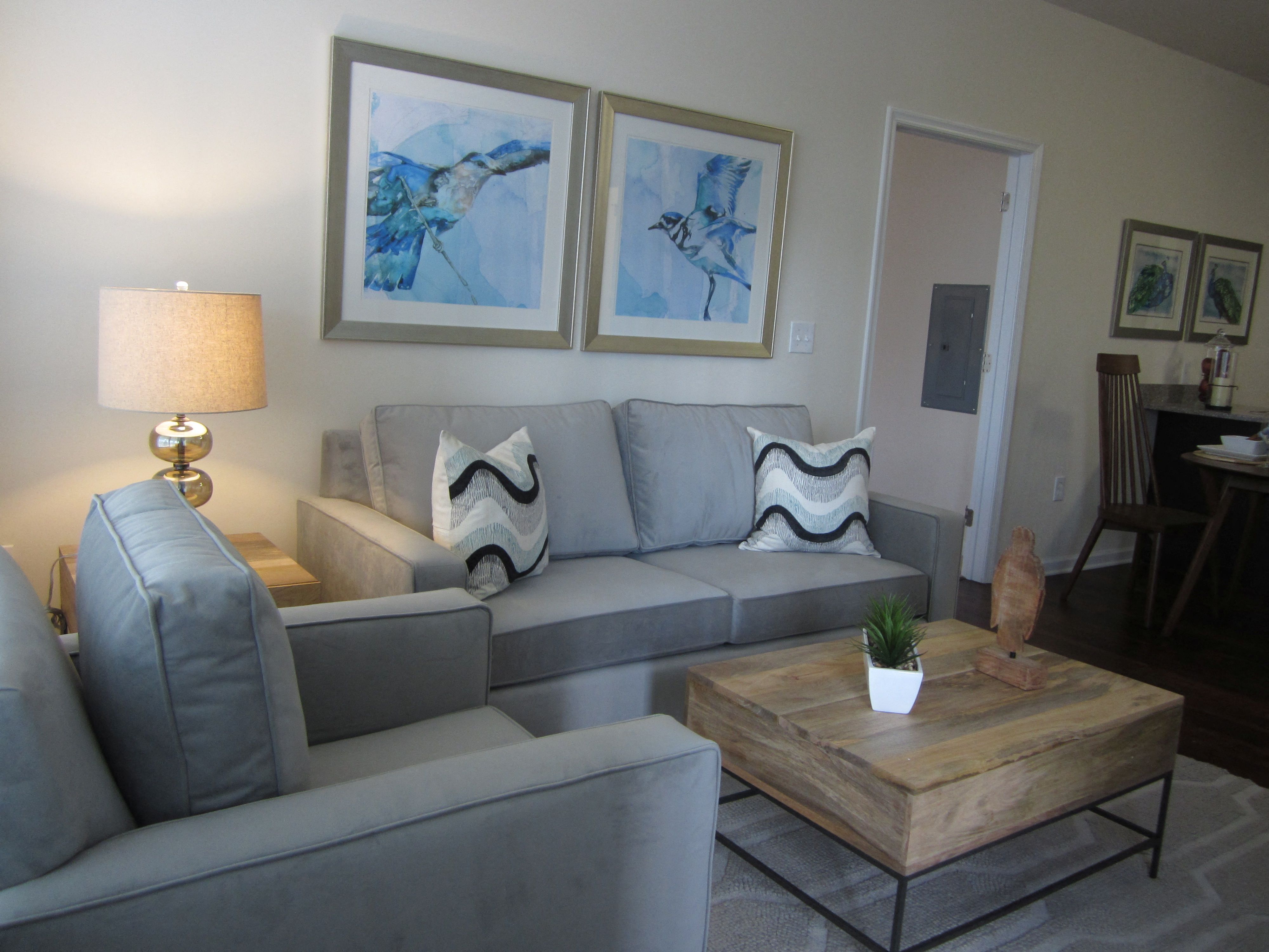 a living room with a gray couch and a coffee table