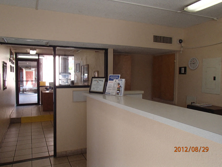 the lobby of an apartment building with a reception desk