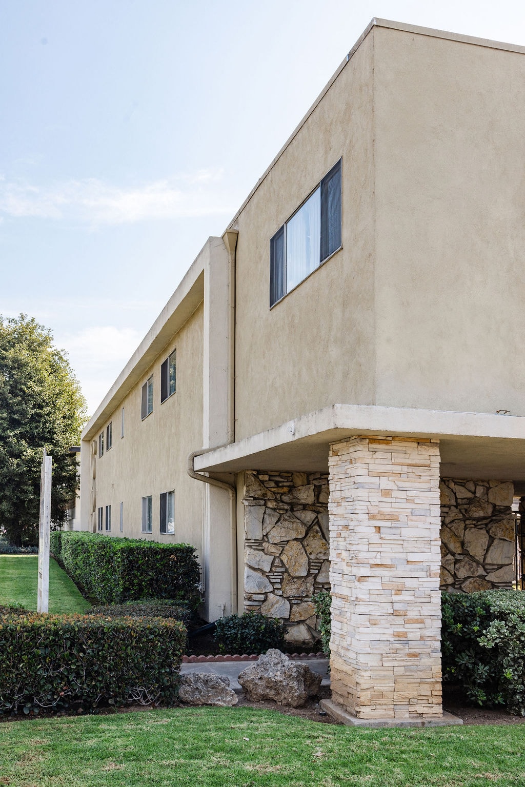 A house with a stone pillar in front of it.