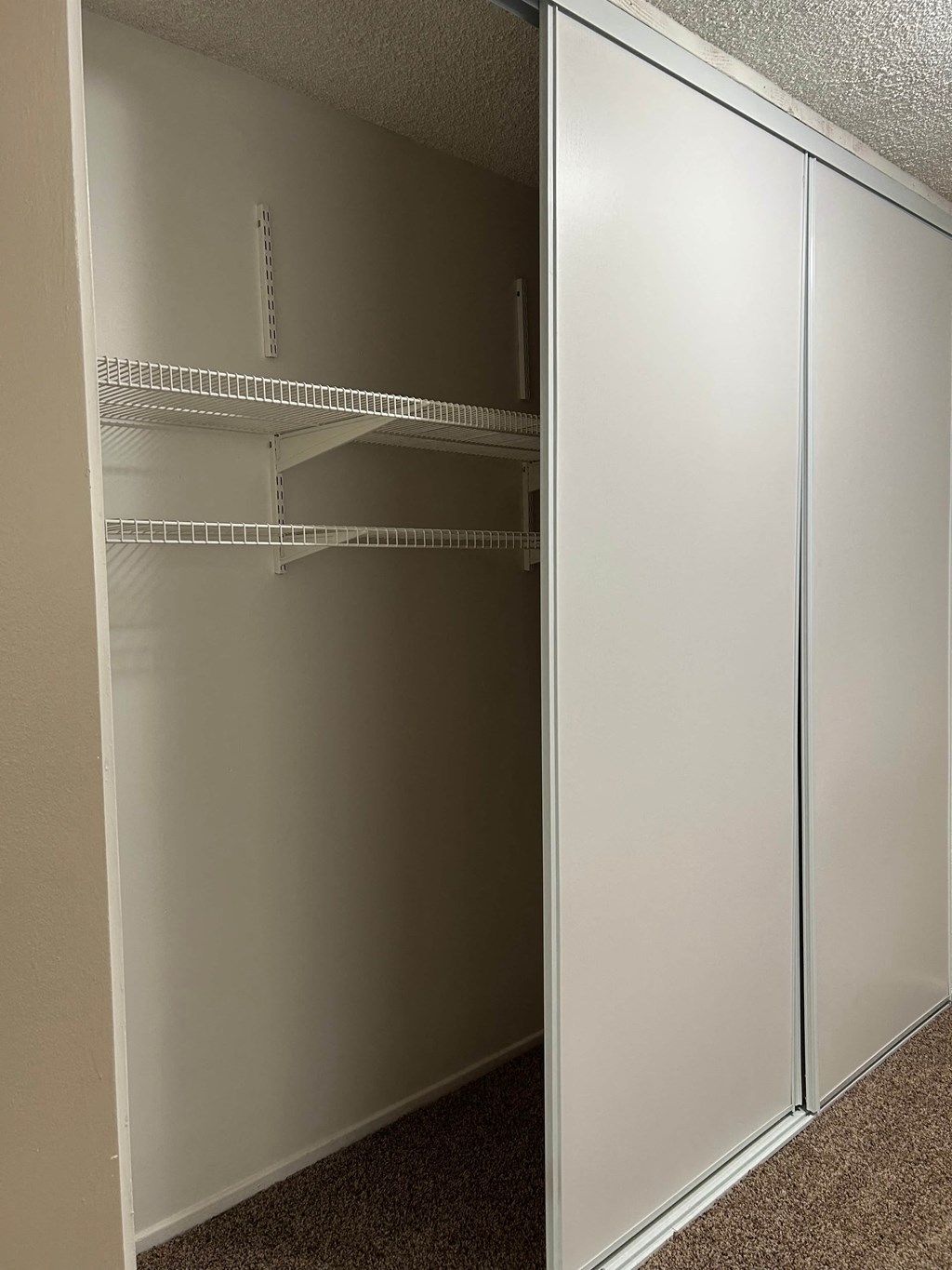 Empty white shelves in a room.