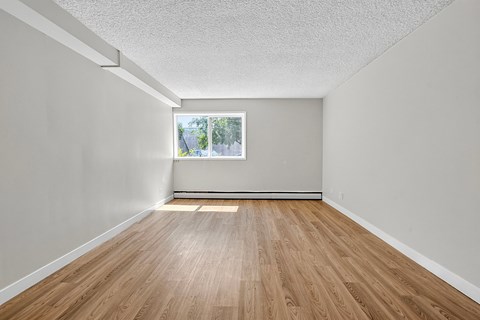 A room with wooden floors and a window.