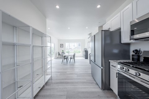 a kitchen with stainless steel appliances and white cabinets