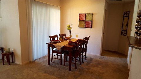 a dining room with a table and chairs in a living room