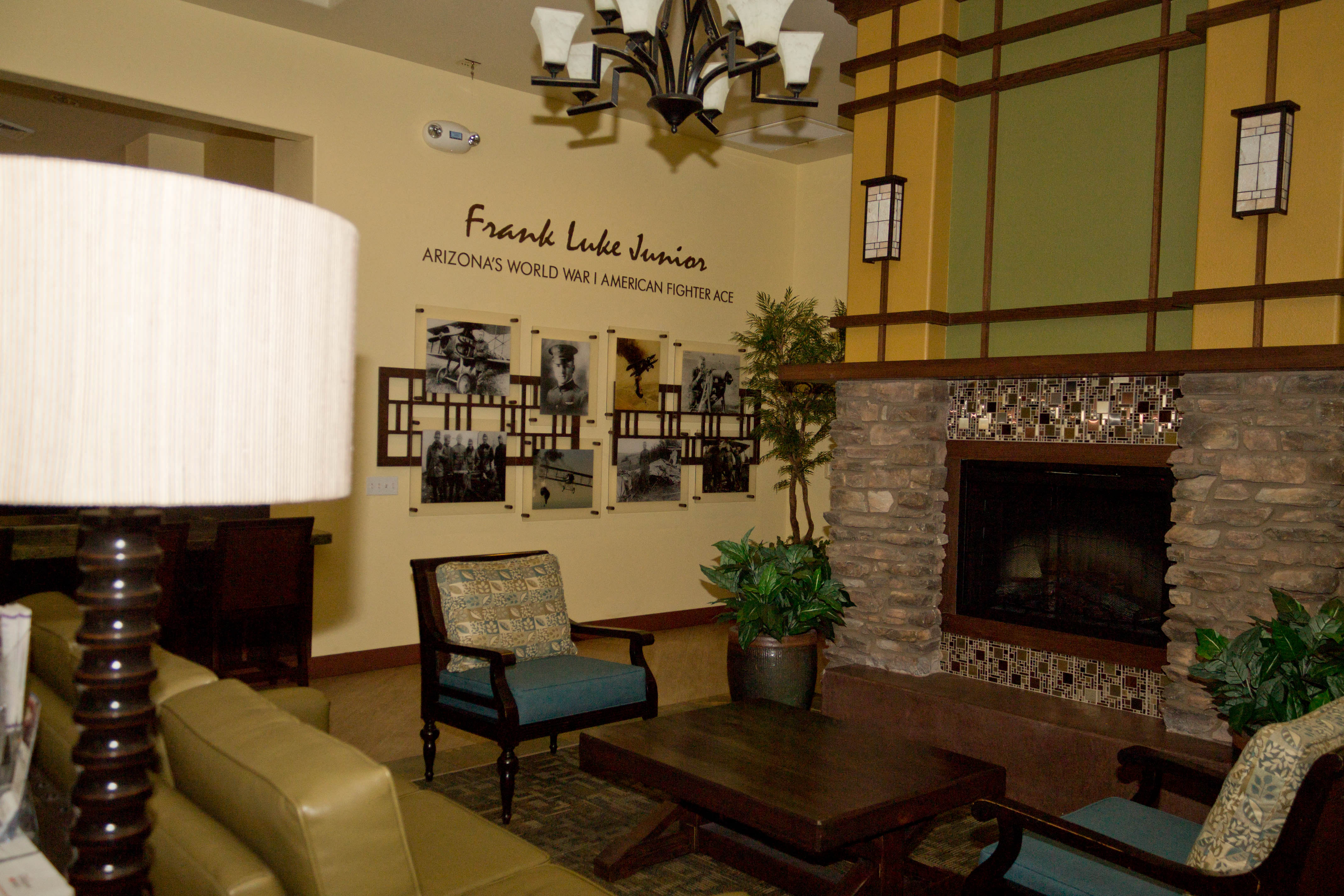 a living room with a fireplace and a table and chairs