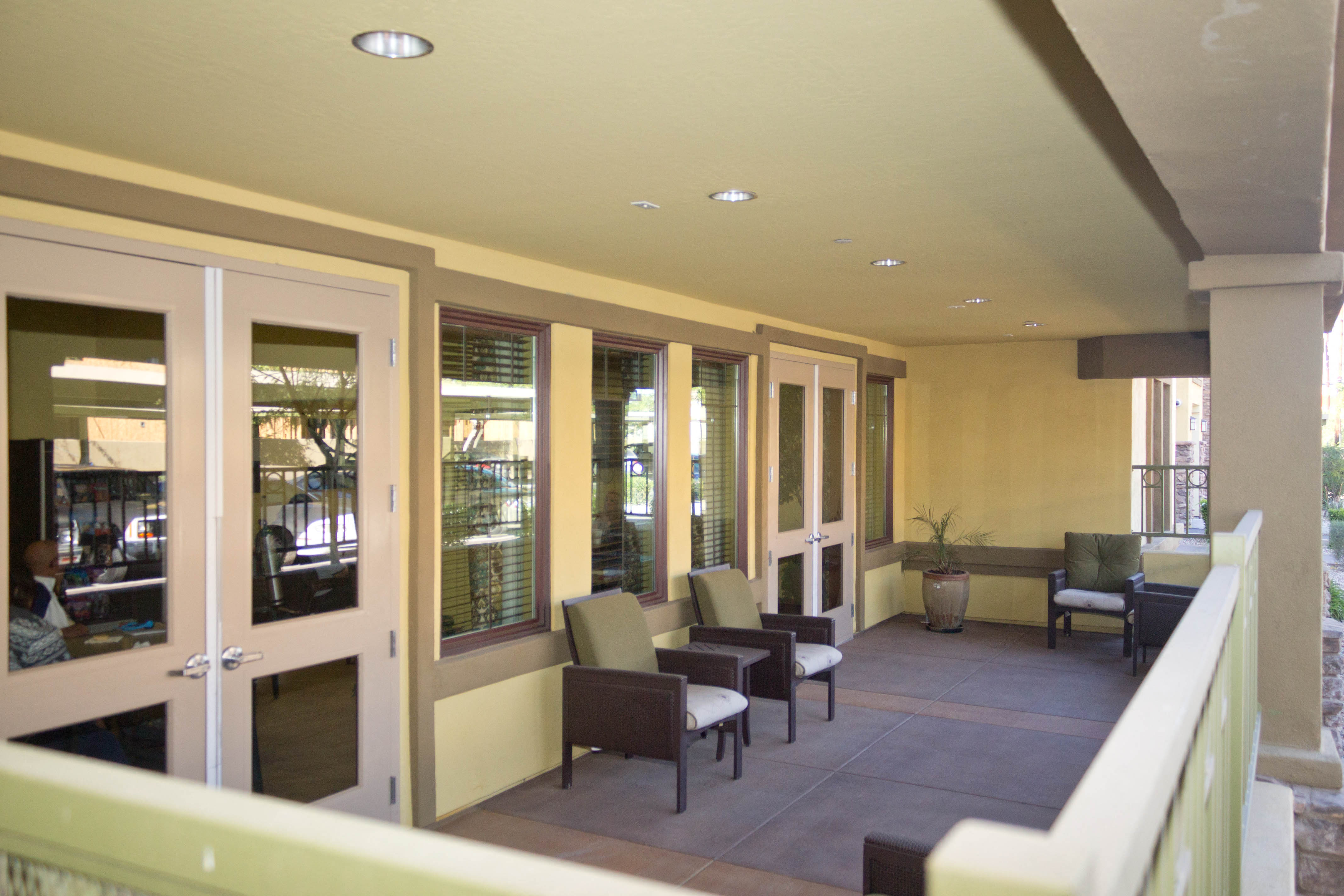 a view of the lobby of a building with chairs and tables