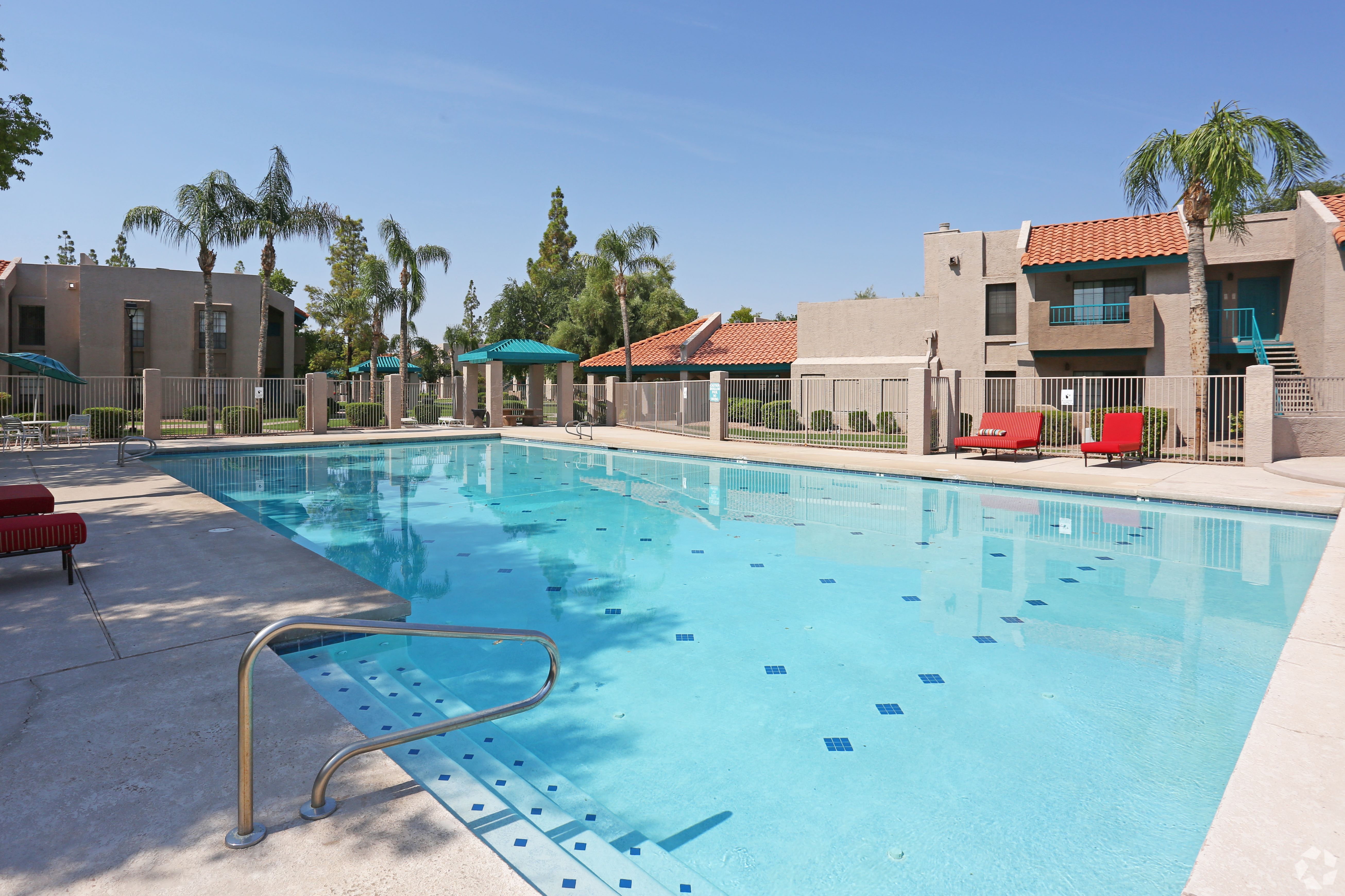A swimming pool with a metal ladder in the middle of it.