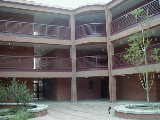 a large building with a courtyard and trees