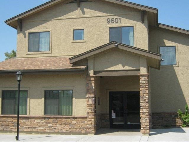a tan brick house with a front door