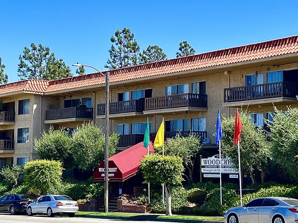 a building with flags in front of it on a street