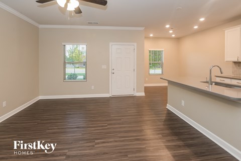 the view of a kitchen and living room from the dining room