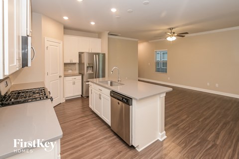 the kitchen is open to the living room and dining room