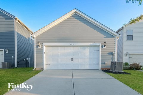 a white and gray house with a white garage door