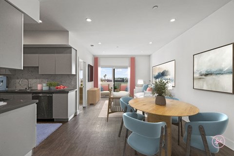 A modern kitchen with a dining table and chairs.
