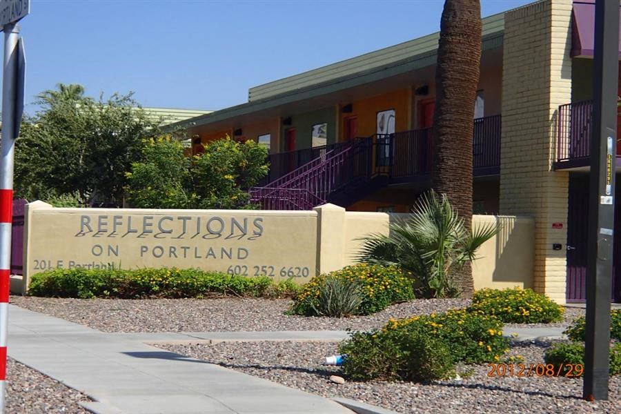 a building with a sign that says reflections