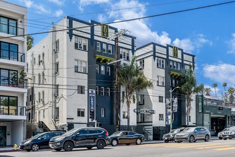 a city street with cars parked in front of a building