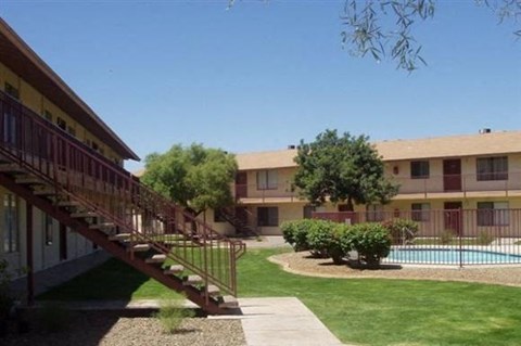 an apartment building with a swimming pool and stairs