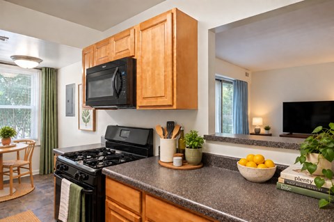 A kitchen with a black microwave above a black stove.
