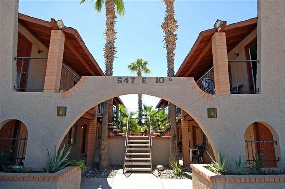 a building with a staircase and palm trees