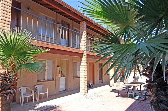 a building with a palm tree outside of it