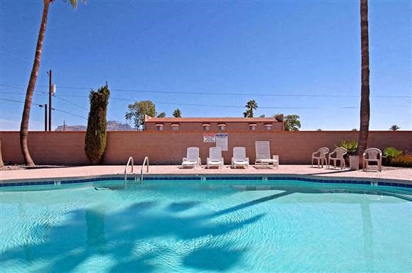 a swimming pool with chairs