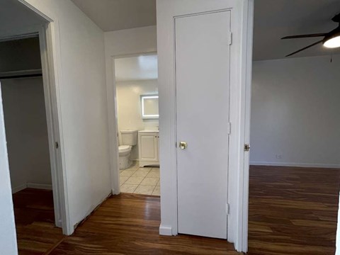a hallway with a door open to a bathroom