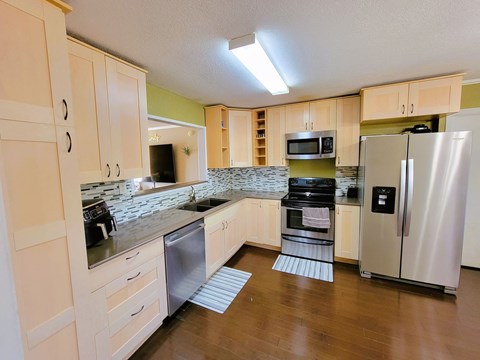 a kitchen with stainless steel appliances and white cabinets
