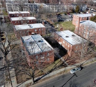 A large brick building with a parking lot in front.